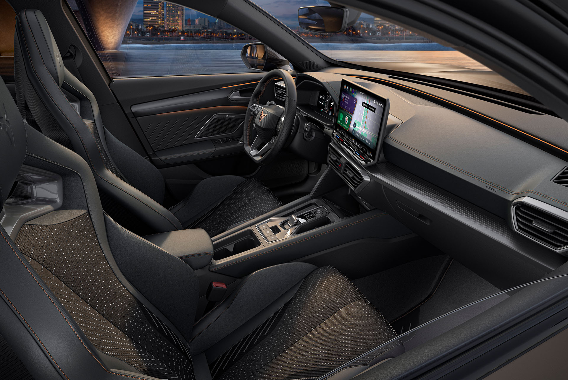Interior view of a new CUPRA Formentor 2024 interior with sporty seats, detailed stitching, a multifunctional steering wheel, large infotainment screens and a sleek dashboard design. The car overlooks a cityscape at dusk through the windshield.