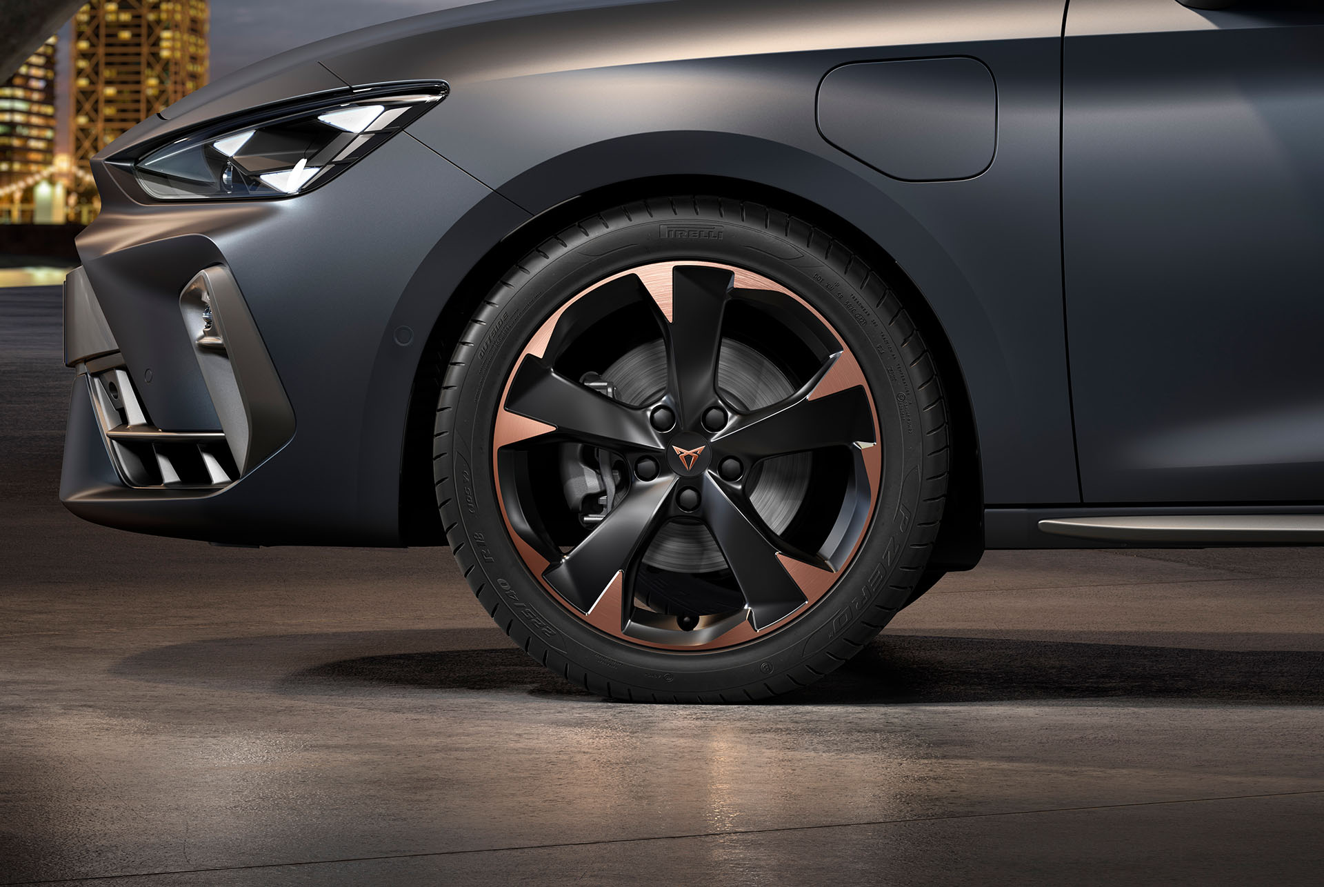 front side view of left mistral garbi copper machined alloy wheels for the new cupra leon sportstourer 2024, tyres, signature headlights and grey body