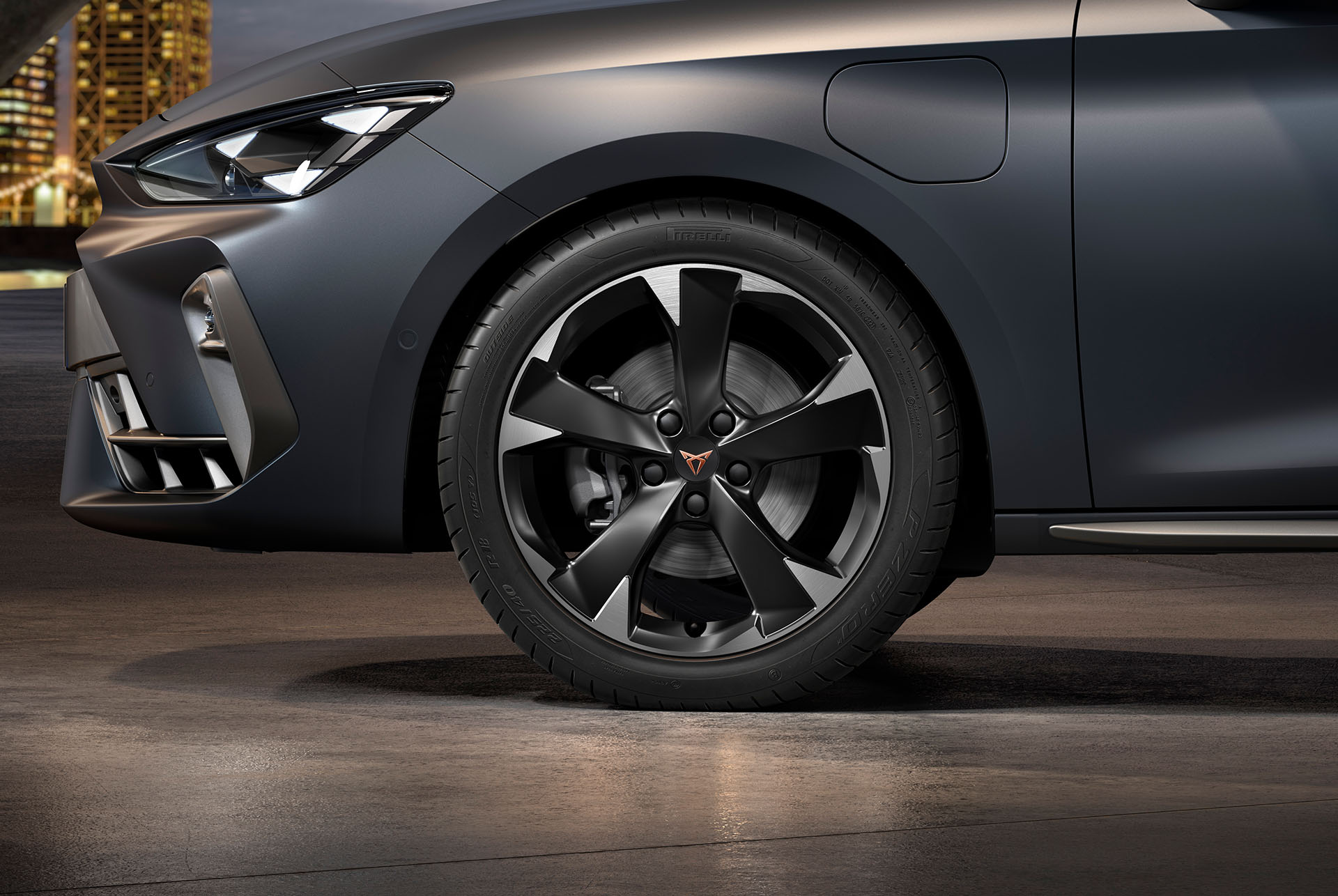 front side view of left machined silver garbi alloy wheel for the new cupra leon sportstourer 2024, tyres, signature headlights and grey body