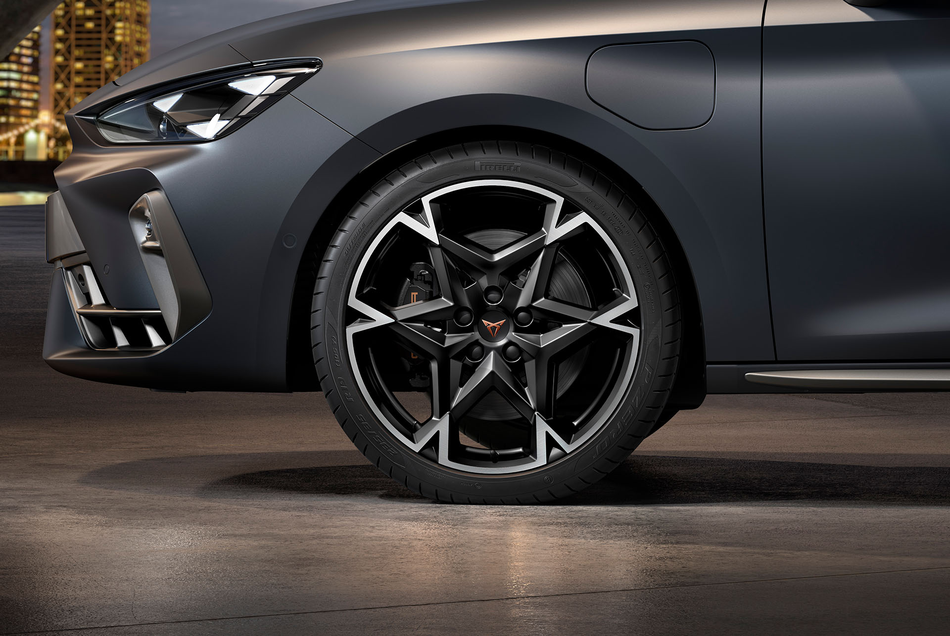 : front side view of left machined polar alloy wheel in black and silver for the new cupra leon 2024, tyres, signature headlights and grey body