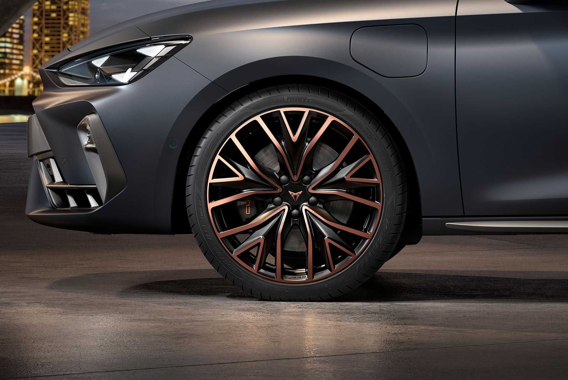 front side view of left mistral copper forged wheels in copper and black for the new cupra leon 2024, tyres, signature headlights and grey body
