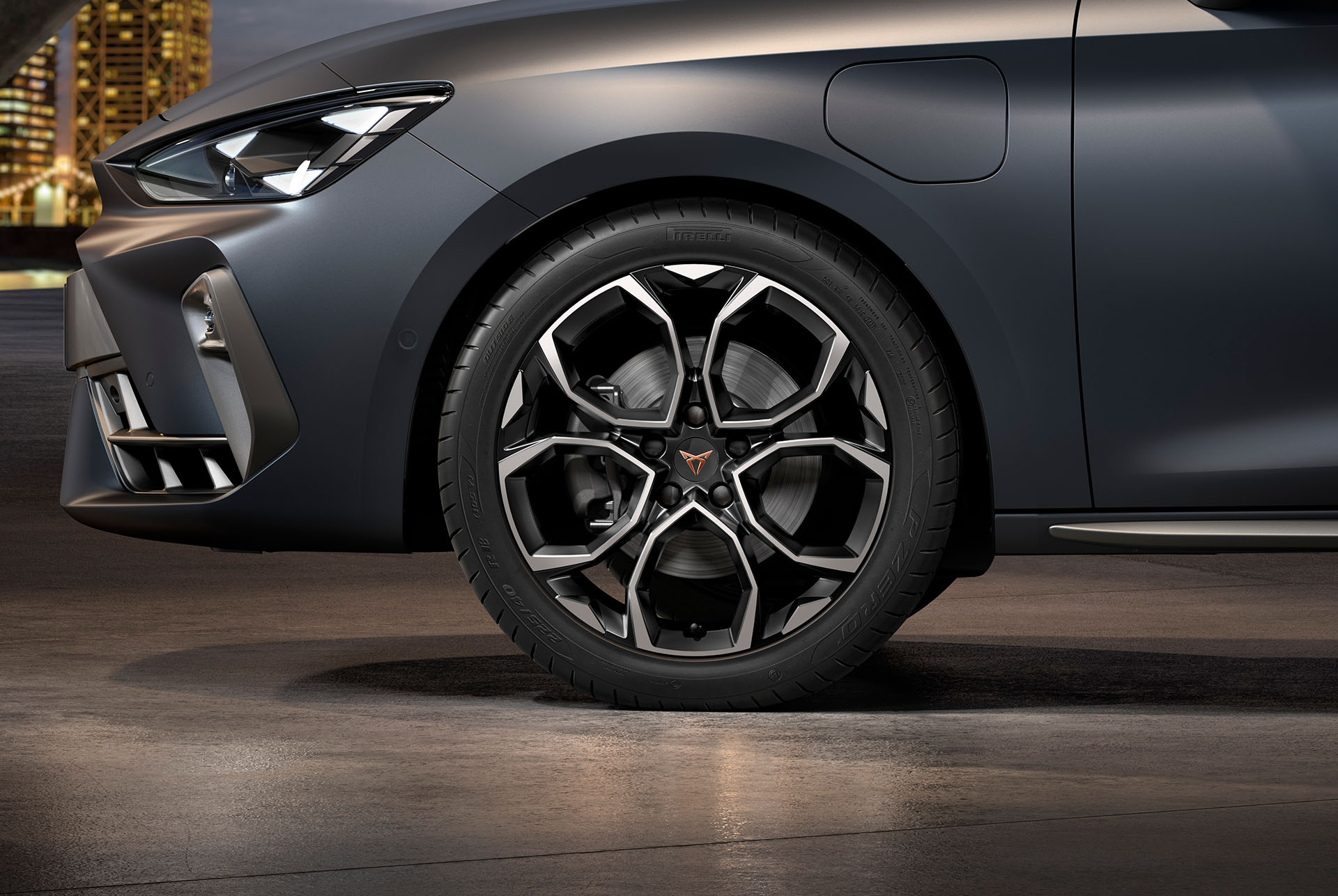front side view of left machined silver and black windstorm alloy wheel for the new cupra leon 2024, tyres, signature headlights and grey body